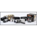 A collection of vintage cameras and accessories to include an early Polaroid Land camera, a Kodak