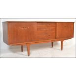 A 20th Century retro teak wood sideboard / credenza, having a central bank of three drawers