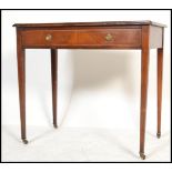 A 19th century mahogany inlaid writing table desk being raised on squared legs with brass castors.