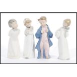 A group of four tall Lladro type Nao figurines to include Child with pillow and clock, Girl with