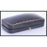 A vintage early 20th century leather jewellery bar brooch box having a gilt tooled edge. Silk