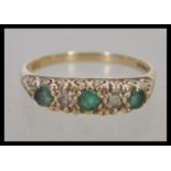 A 9ct / 375 hallmarked gold ring, the emerald approx 30 pts with approx 10 pts diamonds. Size Q.5,