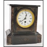 A Victorian 19th century black slate and marble 24 hour mantel clock with faceted hands and roman