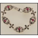 A stamped 925 silver spacer bracelet set with marcasite and rubies. Weight 26.7.