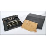 A vintage 20th Century cased Corona folding reporters typewriter, lift up lid, catches to the