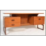 A mid century Donald Gomme for Ernest Gomme G-Plan teak wood writing table desk being raised on