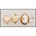 A selection of 9ct gold pendants to include a two hallmarked heart shaped lockets, a cameo pendant
