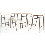 A set of 4 retro 20th century Industrial lab - laboratory stools raised on tubular black metal