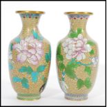 A pair of 20th Century vases Chinese Cloisonne vases decorated with peonies and birds on a yellow