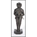 An unusual vintage 20th century scratch built metal figurine of a knight stood to attention.