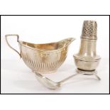 A silver hallmarked creamer jug with makers marks for Thomas Latham & Ernest Morton dating to