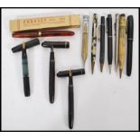 A collection of vintage fountain and other pens to include a Waterman 14ct gold nib, Swan 14ct