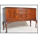 A 20th Century 1930's flame mahogany sideboard raised on cabriole legs. The bow fronted sideboard