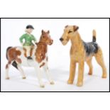 A 20th Century Beswick ceramic Skewbald Pony with a female rider, in green jacket, stamped to base