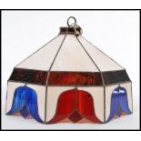 A vintage Tiffany style lamp shade having coloured leaded stained glass panels. Tulip pattern with