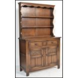 A 20th century Jacobean revival oak dresser in the manner of Jaycee / Old Charm. Cupboards with