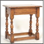 A 20th century solid oak peg jointed coffin table stool. Jacobean revival form with block turned