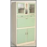 A vintage retro mid 20th Century all in one kitchen larder cupboard having pistachio / mint green