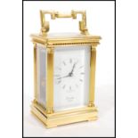 A 20th century modern Comitti of London brass cased carriage clock with Roman numeral chapter