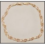 A 9ct gold decorative link bracelet having a curb link with floral spacers and a lobster clasp.