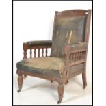 An 19th Century Victorian mahogany library armchair. The chair raised on turned legs with spindle