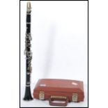 A vintage clarinet musical instrument by Evette complete in fitted case.