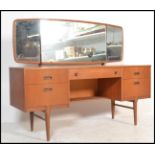 A retro 20th Century kneehole twin pedestal teak wood dressing table, triptych mirror to the top