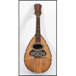 A vintage early 20th century mandolin musical instrument with paper label to interior reading