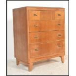 A 1930's Art Deco oak chest of drawers by Lebus. Raised on angled tapering legs with a central