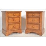 A pair of contemporary hardwood bedside chests of drawers, each raised on a plinth base with a