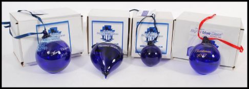 A selection of hand blown Bristol Blue glass Christmas baubles to include a ' Christmas 2015 ' heart