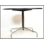 After Charles & Ray Eames - A contemporary round dining table. The table having a black finished oak