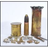 A group of military related items to include various pen knives, cap badges and two artillery
