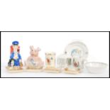 A collection of Royal Doulton Beatrix Potter ceramics to include plates, bowl, money box, a