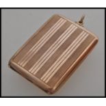 A stamped 375 9ct gold vesta case of square form having striped engraved decoration and loop to