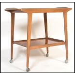 A 1960's retro vintage teak wood two tier cocktail / tea trolley, raised bar handle to one side,