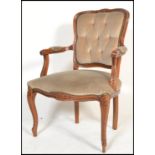 A 20th century beech wood French fauteuil armchair with champagne coloured velour fabric and show