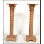 A pair of 20th Century carved wooden bust / jardiniere stands  in the form of composite spiral