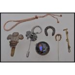 A selection of vintage jewellery items to include a silver white metal hat pin in the form of a