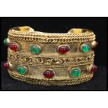 A 1980s signed Chanel Gripoix gold-tone runway bangle bracelet set with green and red Gripoix