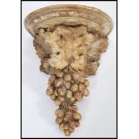 A 20th Century cast composite antique style wall bracket / mount in the form of grapes and vine