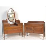 An Edwardian mahogany inlaid dressing table chest being raised on squared legs with castors having a