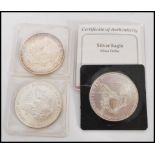 A group of three USA silver Eagle dollars comprising of a 1995 example, 1991 example and an 1987