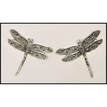A pair of stamped 925 silver stud earrings in the form of dragonflies set with marcasites. Weight