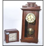 Two vintage early 20th century cased clocks to include a wall hanging mahogany clock with white