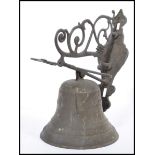 A vintage early 20th century Art Nouveau cast metal bell having cherub and shell mask decoration.