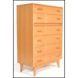 A vintage / retro 20th Century teak chest of six long graduating drawers raised on four