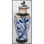 An early 20th century Chinese crackle glazed vase having hand painted blue and white decoration