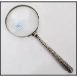 An Edwardian silver handled magnifying glass Adie & Lovekin Ltd., Birmingham 1902, the glass