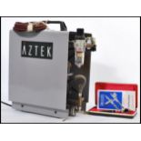 A 20th Century Aztec air brush compressor together with a cased Aerograph Super 63 air brush, the